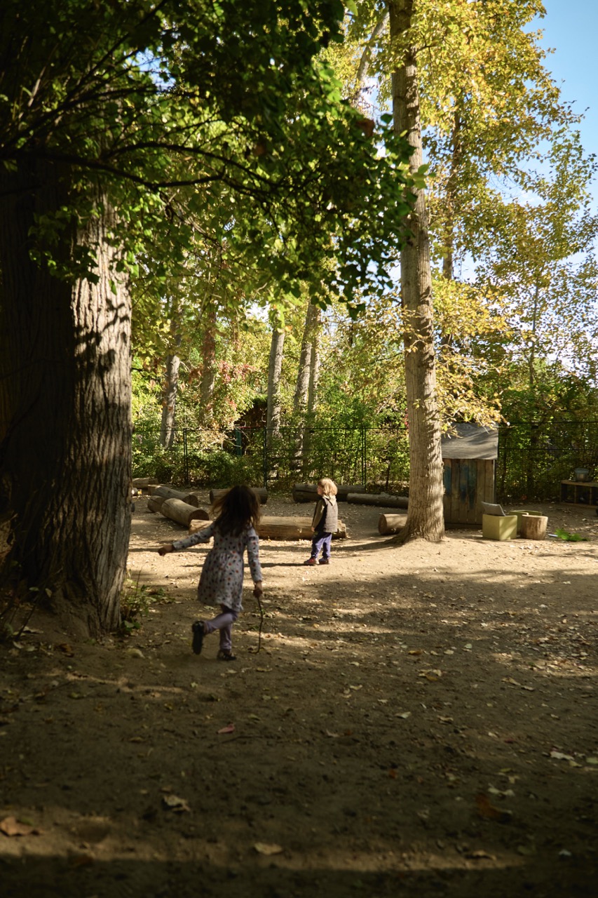 Children exploring and playing together in Bella Vita's outdoor yard
