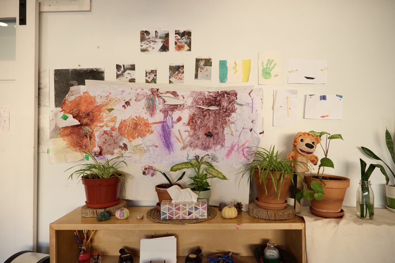 Children's artwork and documentation displayed in a Bella Vita classroom
